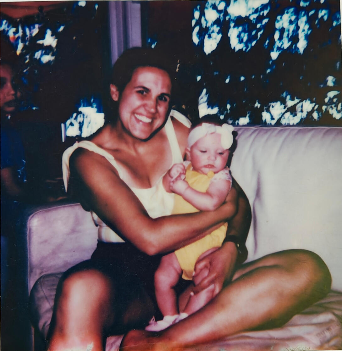 a photo of Andrea holding our newly born daughter right after asking us to move down to Prospect